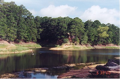 Ten acre lake at Bastrop State Park- Cabin in the background