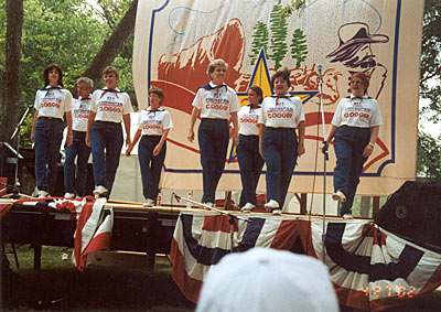 The Clickety Cloggers of Austin performing on stage.